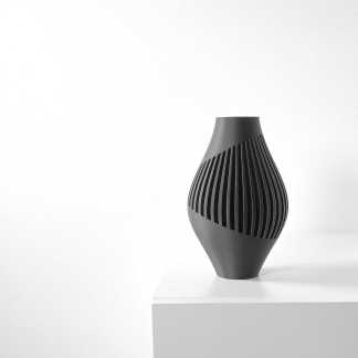 A black modern decorative vase with unique cut-out design, ideal for contemporary interior decor.