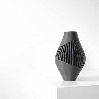 Elegant black sculptural vase with vertical cutouts, perfect for contemporary interiors.