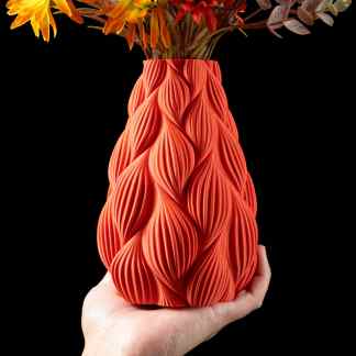 Stylish 3D-printed vase showcasing detailed textured surface and vibrant orange color for contemporary interiors.