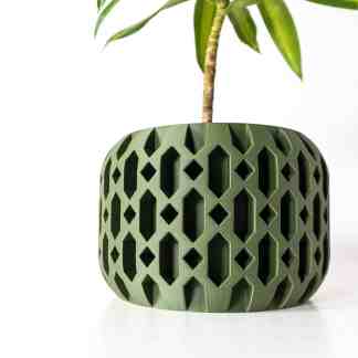 Stylish 3D-printed green plant pot with geometric cutouts, perfect for indoor plants and contemporary decor.