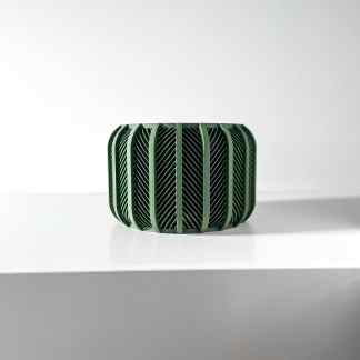 Sleek green 3D-printed design object with intricate patterns, highlighting advanced manufacturing techniques.