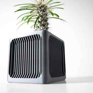 Close-up of a sleek, black 3D-printed plant holder with a lush green plant, showcasing innovative 3D printing technology.