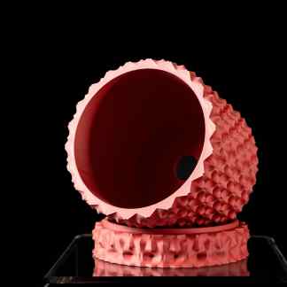 Detailed pink 3D printed fidget spinner with textured grip, used for stress relief and focus enhancement.
