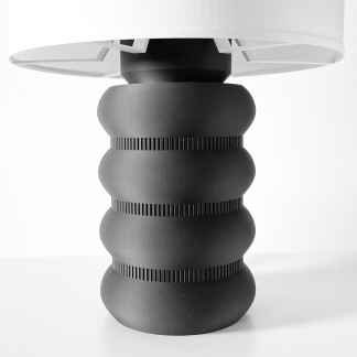 Black table lamp with innovative geometric base for contemporary interior design.