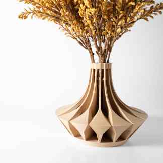 A 3D printed beige geometric vase holding dried yellow flowers, highlighting innovative design and additive manufacturing.