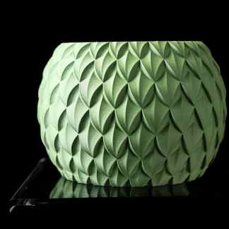 Bright green 3D printed vase with intricate leaf pattern on a black background.