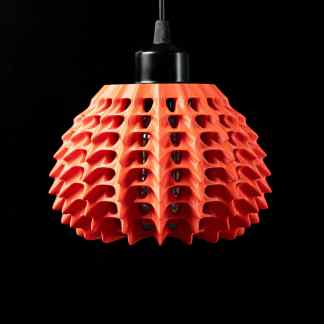Bright red 3D-printed pendant lamp with honeycomb pattern, perfect for contemporary home lighting.