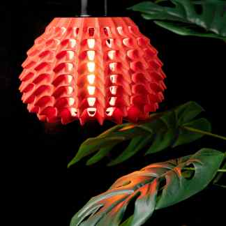 Vibrant red 3D printed pendant lamp with detailed honeycomb pattern, eco-friendly home decor lighting.