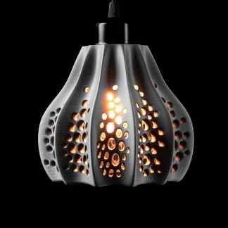 Stylish black pendant lamp with artistic perforations and warm lighting, ideal for contemporary interiors.