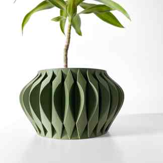 Vase made with advanced 3D printing technology, featuring a unique geometric design and a lush plant.