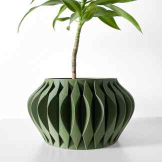 Vase with intricate 3D printed geometric design holding a plant, showcasing innovative 3D printing art.