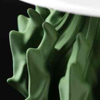 Close-up of a detailed green leaf made with 3D printing technology showcasing realistic texture and form.