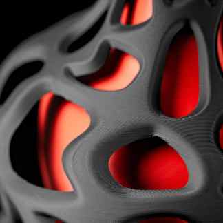 Close-up of advanced 3D-printed design with black and red color contrast, showcasing intricate details.