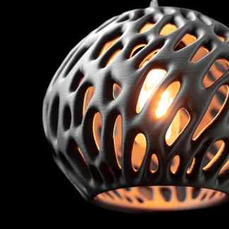 Futuristic 3D printed pendant with intricate lattice design and glowing interior, showcasing innovative 3D printing art.