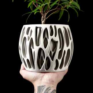 High-quality 3D printed plant pot showcasing intricate, artistic patterns for home décor.
