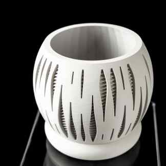 Elegant white 3D-printed vase featuring intricate geometric cutouts, showcasing innovative design and craftsmanship.