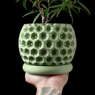Vibrant green 3D-printed plant pot with intricate geometric patterns for modern home decor.