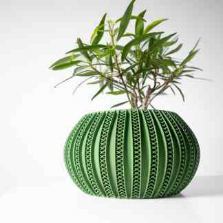 3D-printed green ceramic plant pot with intricate design and healthy leafy plant, demonstrating digital manufacturing excellence.
