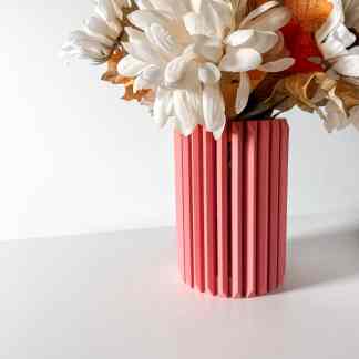 Vibrant pink flower vase with textured vertical ridges, ideal for enhancing interior spaces.
