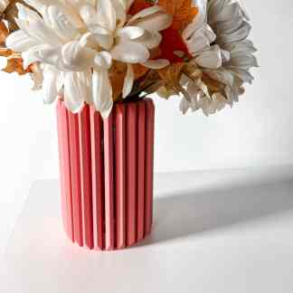Colorful artificial flower arrangement in 3D-printed vase, stylish home decoration.