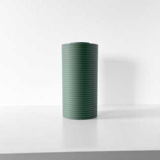 Decorative green ceramic vase with ribbed design, ideal for modern interior styling.