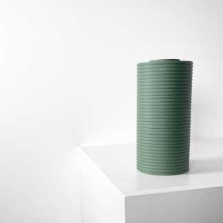 Elegant green ceramic vase with ribbed texture, perfect for stylish interior decoration.
