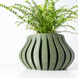 Vase with green plant showcasing innovative 3D printing design, perfect for modern home or office decor.