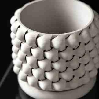 3D printed vase with detailed textured surface in white, demonstrating innovative 3D printing design.