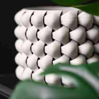 Sleek white 3D-printed vase showcasing advanced additive manufacturing techniques.