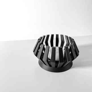 Dark-colored modern geometric candle holder with sturdy base, designed for contemporary décor.