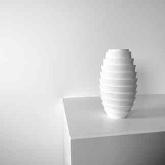 Stunning 3D printed white vase with a layered, modern aesthetic, ideal for stylish interior decoration.