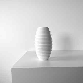 Minimalist white 3D printed vase on display.