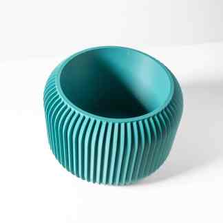 A vibrant turquoise 3D printed vase with vertical ridges, showcasing innovative design and craftsmanship.