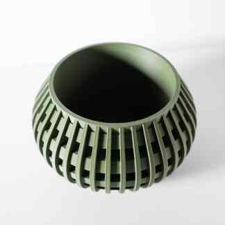 An intricate, eco-friendly 3D-printed green plastic vase with a modern design and detailed ridges.