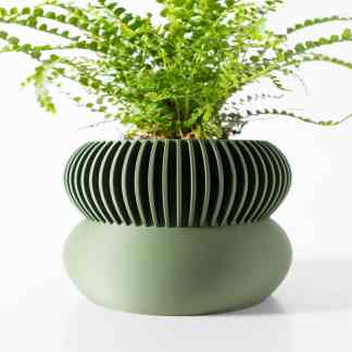 Stylish green fern in a 3D-printed ceramic planter, perfect for modern home decor.