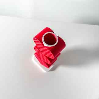High-quality 3D printed red plastic cylindrical part with a hollow center, showcasing detailed layer resolution.