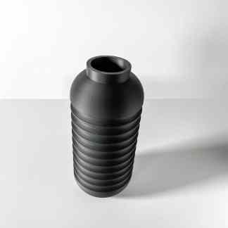 High-quality 3D printed black vase with ribbed design, showcasing innovative printing technology.