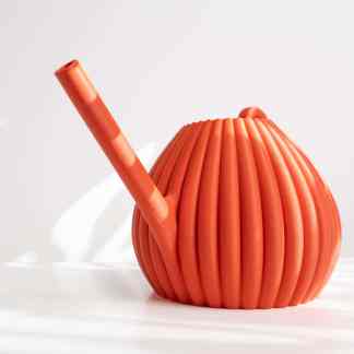 Bright orange 3D printed watering can with ridged surface, perfect for gardening.