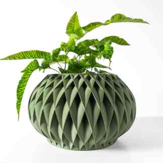 3D printed geometric plant pot with intricate design and lush green foliage, ideal for modern interior spaces.