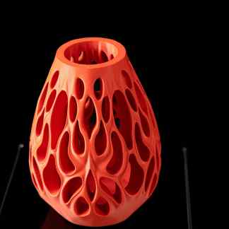 Vibrant orange 3D-printed Vesselflower vase with intricate openwork design, ideal for modern decor.