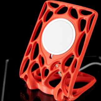 High-quality red 3D-printed wireless phone stand with intricate open design.