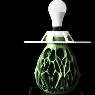 A modern lamp featuring intricate 3D-printed green and white components, showcasing advanced 3D printing technology.