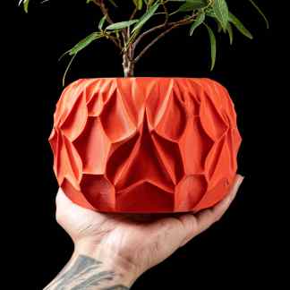 Colorful 3D printed plant pot featuring intricate geometric patterns, showcased by AM Square 3D.
