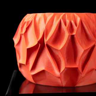 Vibrant orange 3D printed geometric vase with faceted design, perfect for modern home decor.