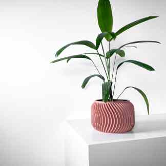 Indoor decorative plant in a stylish pink ceramic planter with ridged design.