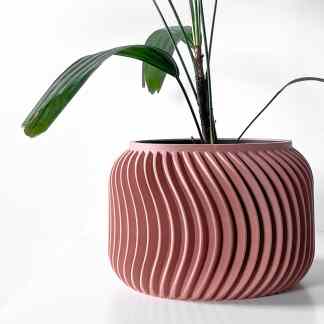 3D printed flower pot with a textured spiral pattern in pink, highlighting advanced manufacturing and customizable home decor.