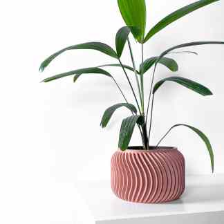 Vibrant green houseplant in a stylish pink textured ceramic pot for modern home decor.
