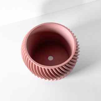 Pink ribbed ceramic-looking 3D printed vase with textured surface and hollow interior, suitable for modern home decor.