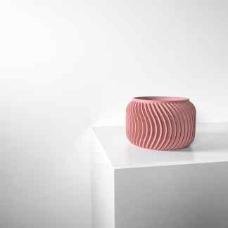 Stylish pink ribbed vase for home decor, accent piece, modern design, interior styling.
