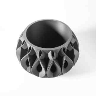 Detailed 3D-printed geometric prototype with intricate lattice design, showcasing additive manufacturing craftsmanship.
